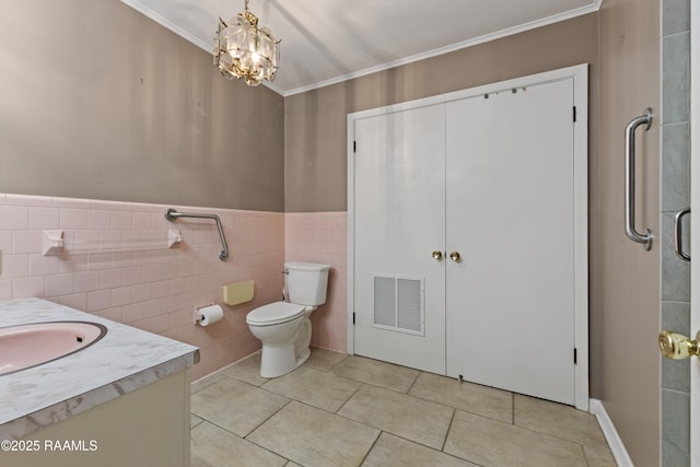 bathroom featuring visible vents, ornamental molding, vanity, and tile patterned flooring