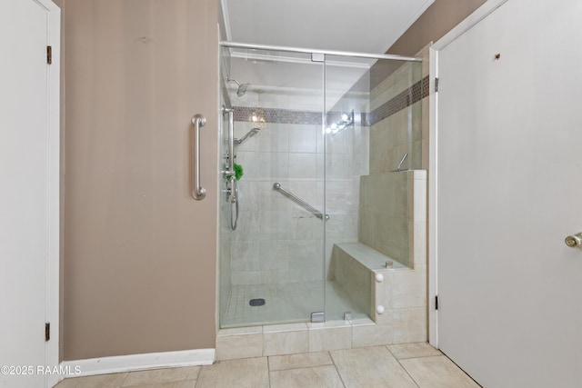 bathroom with tile patterned flooring and a shower stall