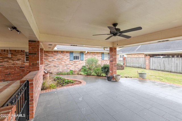 view of patio featuring a ceiling fan and fence