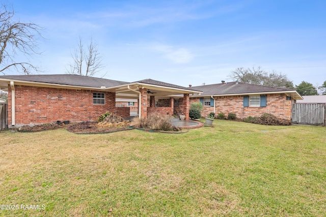 rear view of property featuring brick siding, a patio area, fence, and ceiling fan