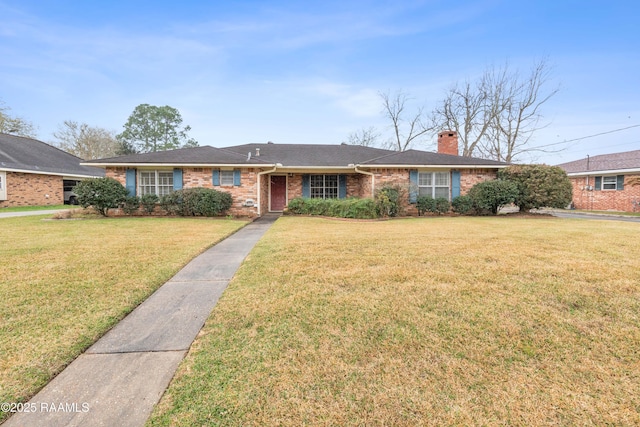 single story home featuring a front lawn, brick siding, and a chimney