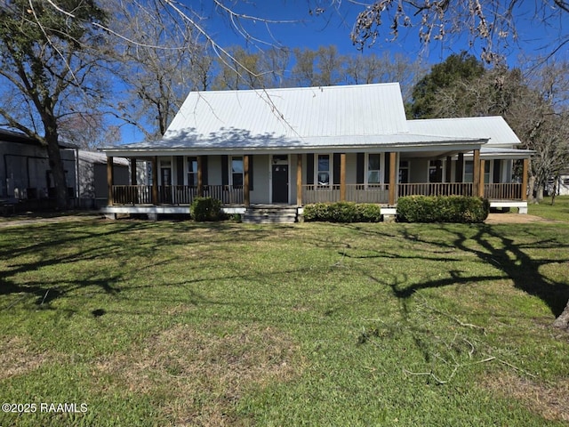 farmhouse-style home with covered porch, metal roof, and a front lawn