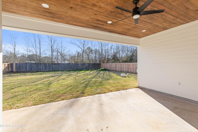 view of yard with a patio area, ceiling fan, and a fenced backyard