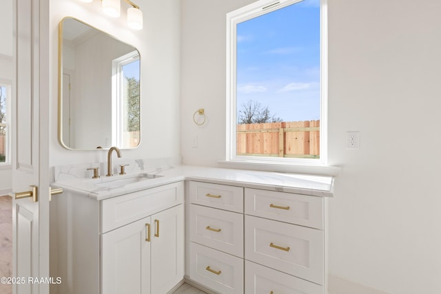 bathroom featuring a healthy amount of sunlight and vanity