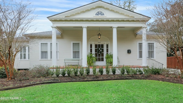 neoclassical / greek revival house featuring a front yard