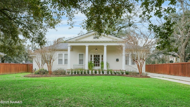 neoclassical home with a front yard and fence