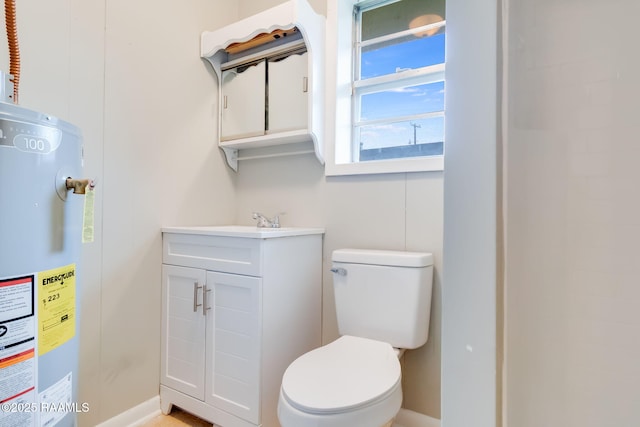 bathroom featuring water heater, vanity, and toilet