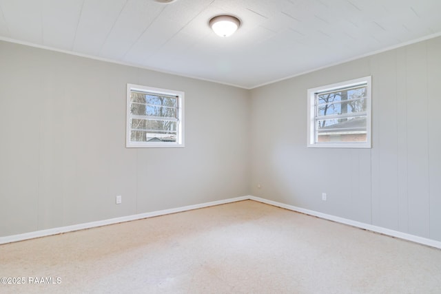 empty room featuring baseboards and a healthy amount of sunlight