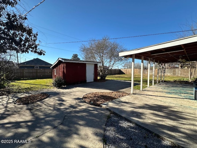 exterior space with a patio area, fence, and an outdoor structure