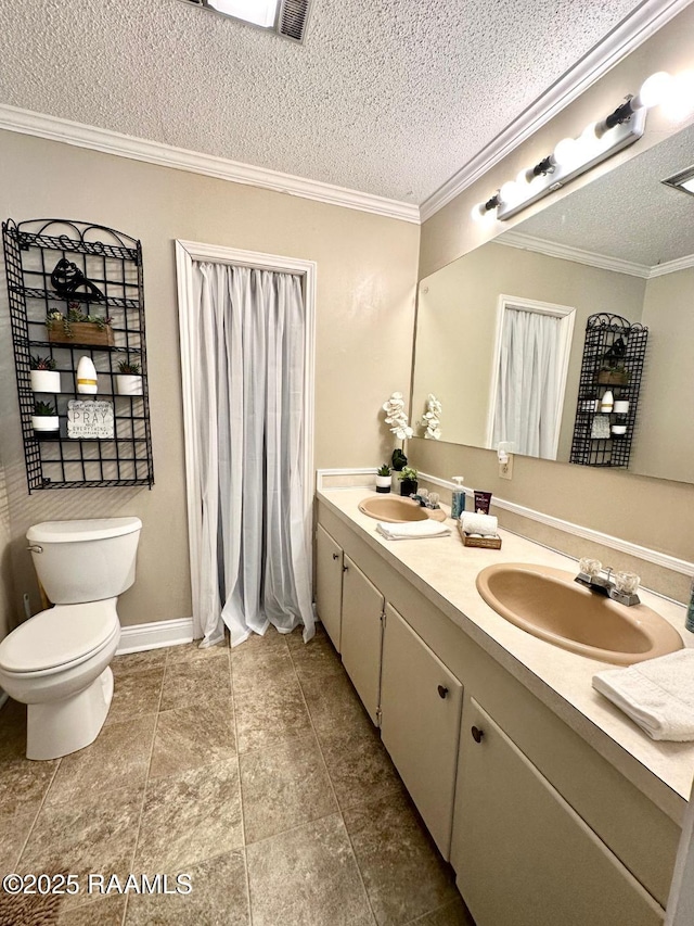 bathroom featuring a textured ceiling, ornamental molding, a sink, and toilet