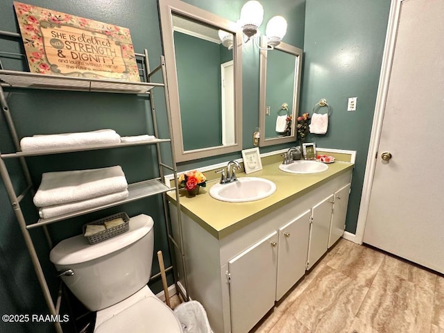 full bath with double vanity, a sink, and toilet