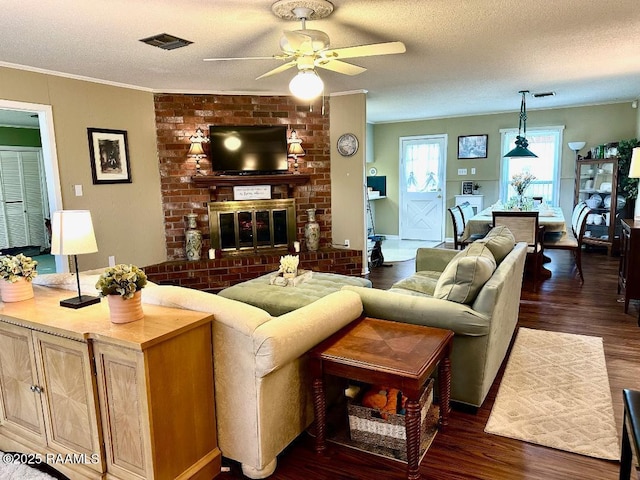 living room featuring a textured ceiling, dark wood-type flooring, and visible vents