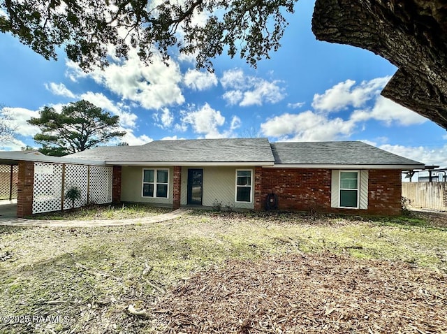 view of front facade with brick siding and fence