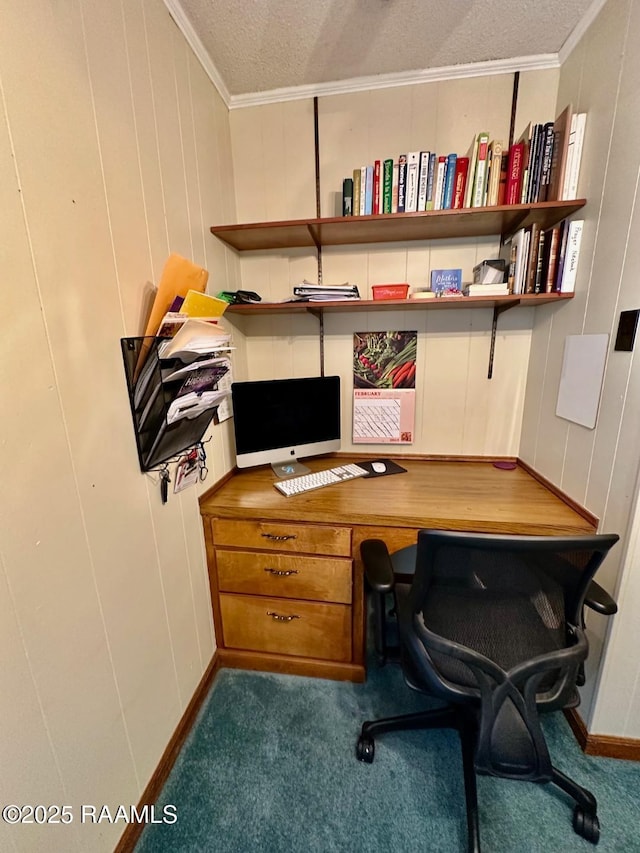 office space with ornamental molding, built in desk, and carpet