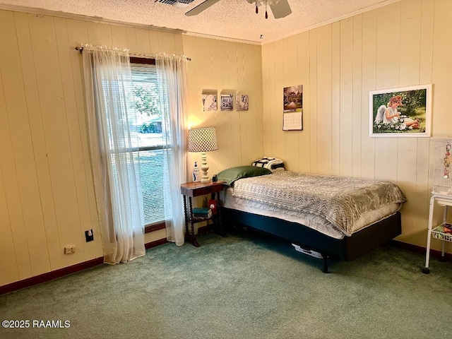 bedroom with carpet floors, crown molding, ceiling fan, a textured ceiling, and baseboards