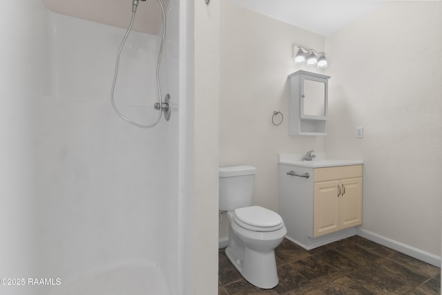 full bath with a shower, baseboards, vanity, and toilet