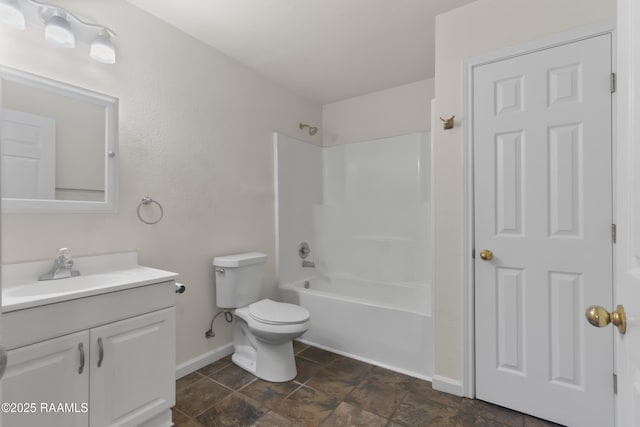 bathroom featuring toilet, bathtub / shower combination, vanity, and baseboards