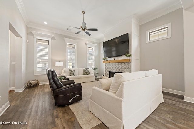 living area with ceiling fan, ornamental molding, dark wood-style flooring, and baseboards