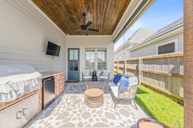 view of patio featuring fence, outdoor lounge area, a ceiling fan, and area for grilling