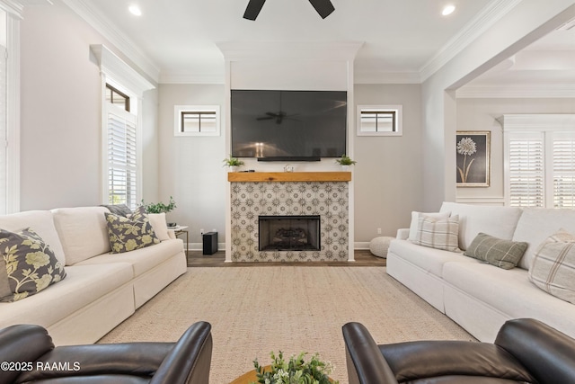 living room with ornamental molding, plenty of natural light, wood finished floors, and a ceiling fan