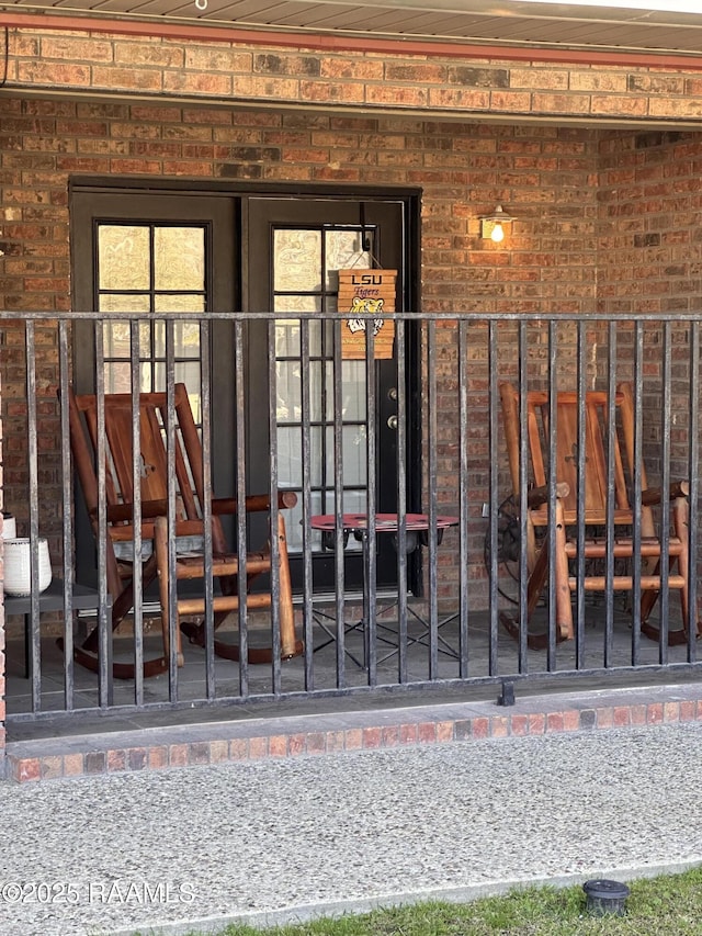 doorway to property with brick siding