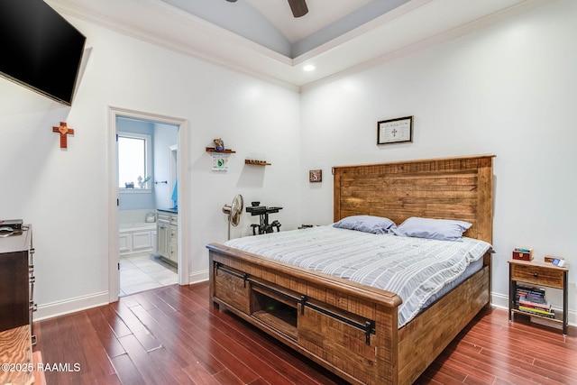 bedroom with vaulted ceiling, ornamental molding, dark wood-style flooring, and baseboards