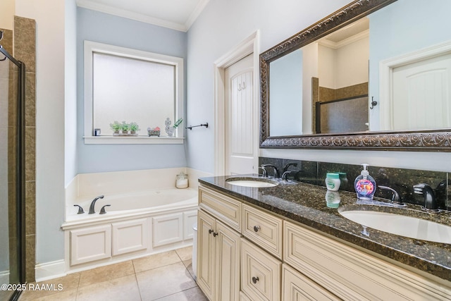 full bathroom featuring a bath, ornamental molding, a sink, and tile patterned floors