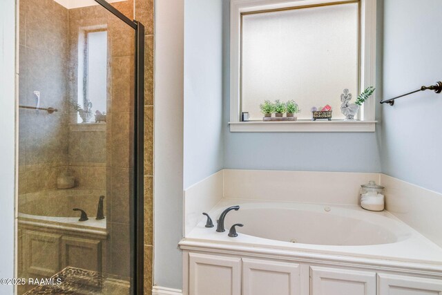 full bathroom featuring a stall shower and a bath