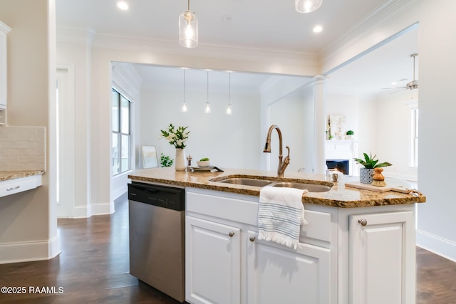 kitchen with a sink, white cabinetry, stainless steel dishwasher, decorative light fixtures, and crown molding