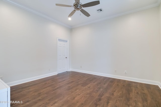 spare room featuring a ceiling fan, visible vents, baseboards, ornamental molding, and dark wood-style floors