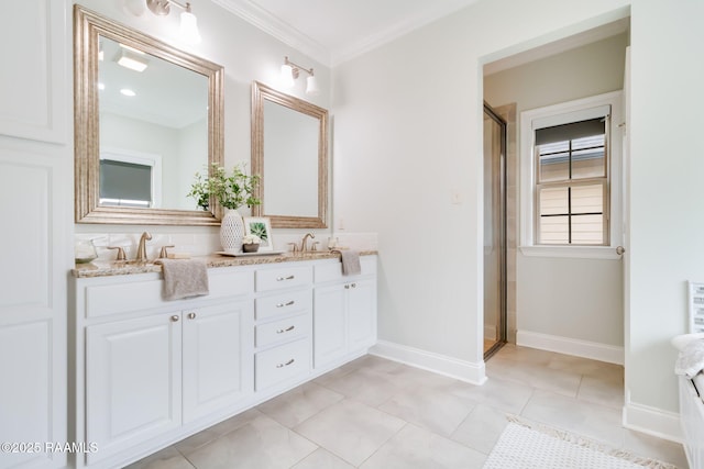 bathroom with tile patterned floors, a sink, a shower with shower door, and crown molding