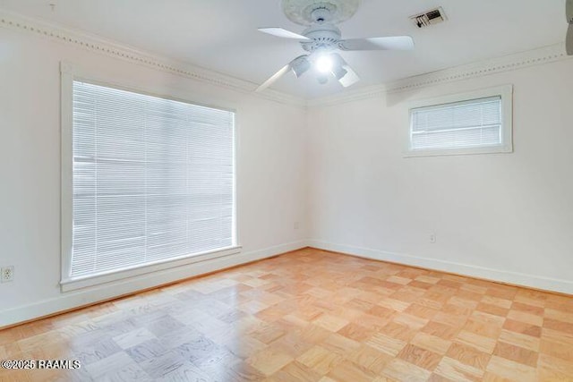 unfurnished room with visible vents, baseboards, and crown molding