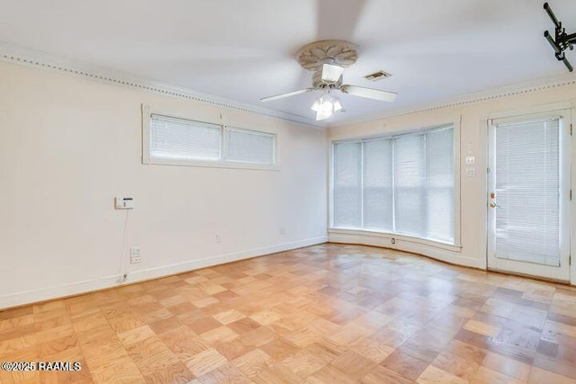 empty room featuring visible vents, baseboards, and a ceiling fan