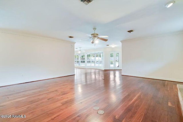 unfurnished room with french doors, baseboards, visible vents, and wood finished floors