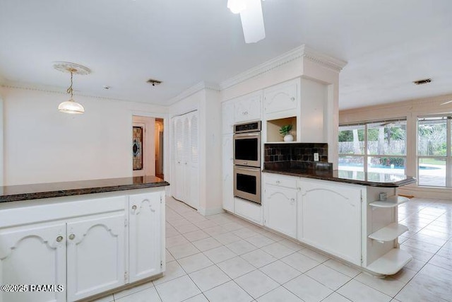 kitchen with dark countertops, stainless steel double oven, white cabinets, and open shelves