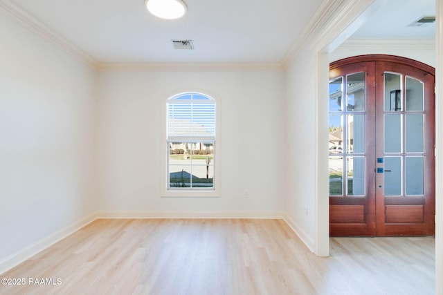 entryway featuring french doors, visible vents, light wood-style flooring, ornamental molding, and baseboards