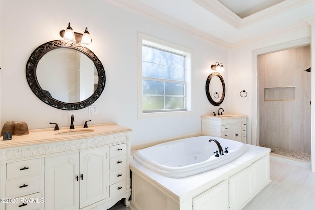 bathroom featuring tiled shower, ornamental molding, a jetted tub, a sink, and two vanities