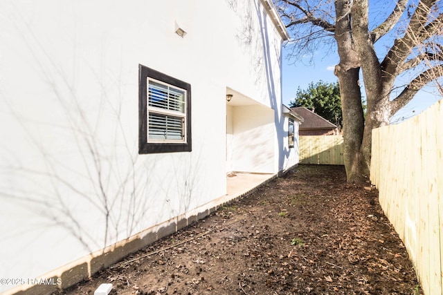 view of side of home featuring a fenced backyard