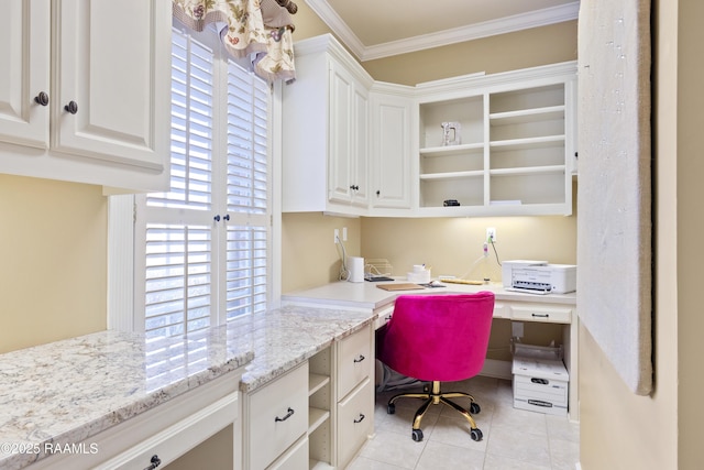 home office with built in desk, light tile patterned flooring, and crown molding