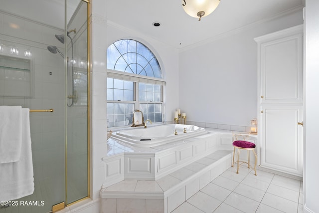 bathroom with a garden tub, a shower stall, and ornamental molding