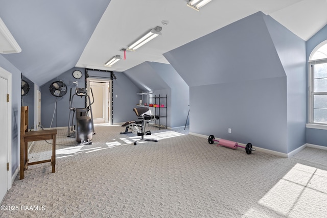 workout room with carpet floors, vaulted ceiling, and baseboards