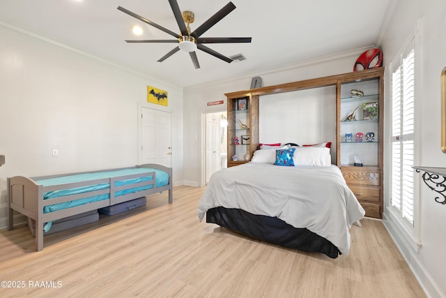 bedroom featuring ornamental molding, visible vents, multiple windows, and wood finished floors