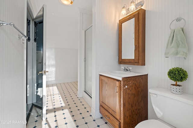 bathroom with toilet, a stall shower, tile patterned floors, and vanity