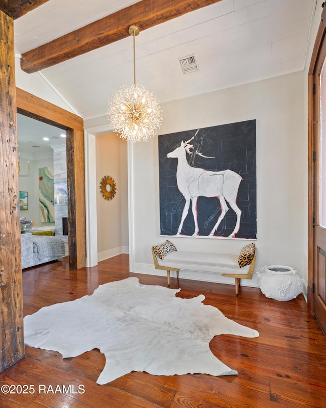 dining space with baseboards, visible vents, lofted ceiling with beams, hardwood / wood-style floors, and a notable chandelier