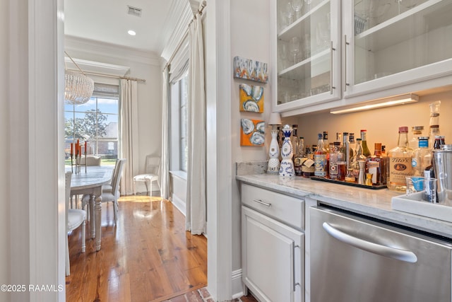 bar featuring recessed lighting, wood finished floors, visible vents, stainless steel dishwasher, and crown molding