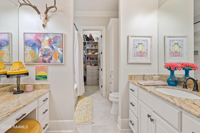 full bathroom featuring crown molding, toilet, vanity, baseboards, and tile patterned floors