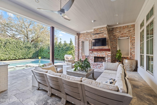 view of patio / terrace featuring an outdoor living space with a fireplace, a ceiling fan, and an outdoor pool