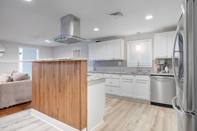 404 Senior Aly, Abbeville, LA 70510 - kitchen featuring visible vents, a sink, appliances with stainless steel finishes, island range hood, and light wood finished floors