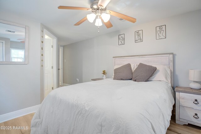 404 Senior Aly, Abbeville, LA 70510 - bedroom with visible vents, baseboards, wood finished floors, and a ceiling fan
