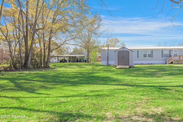 404 Senior Aly, Abbeville, LA 70510 - view of yard with a carport, a storage unit, and an outbuilding